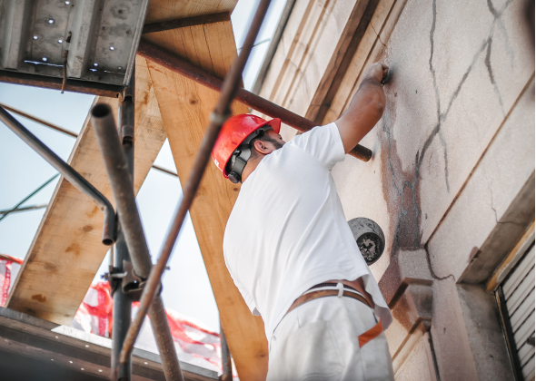 Construction worker fixes a house